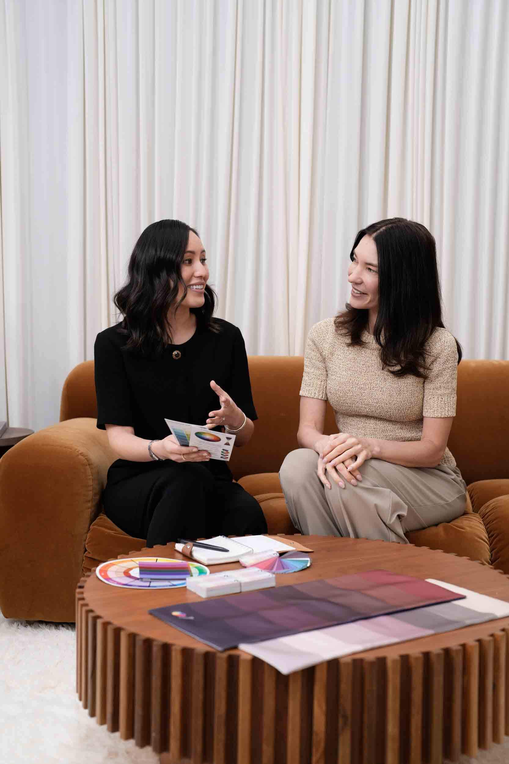 Gulinka and a client considering blush pieces on a boutique rail