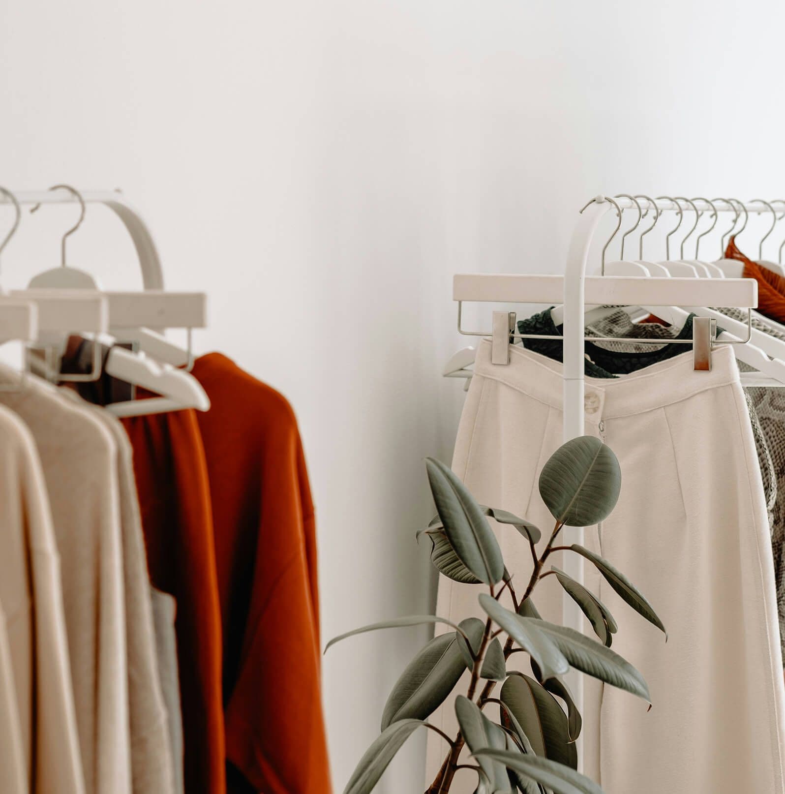 A styled rack of patterned shirts and dresses